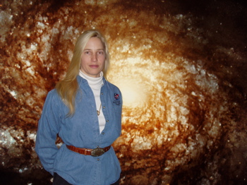 Darlene Kellner in front of Hubble Space Telescope Spiral Galaxy Picture